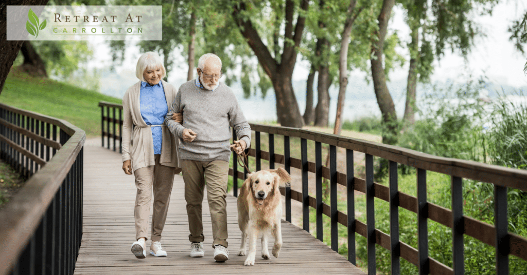 Pet-Friendly Assisted Living: a happy smiling couple walking with a dog.